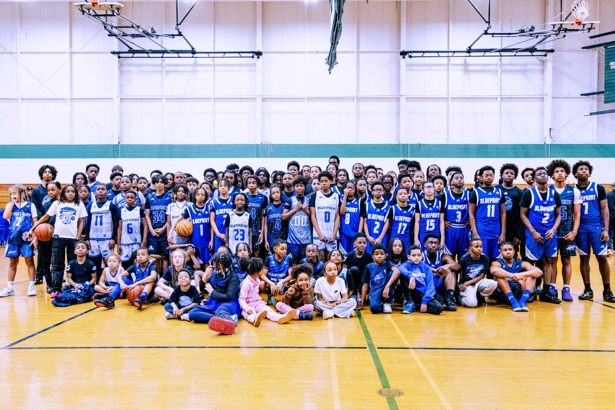 BLUEprint Hoops TRUE BLUE players in blue and white BLUEPRINT jerseys together on the court